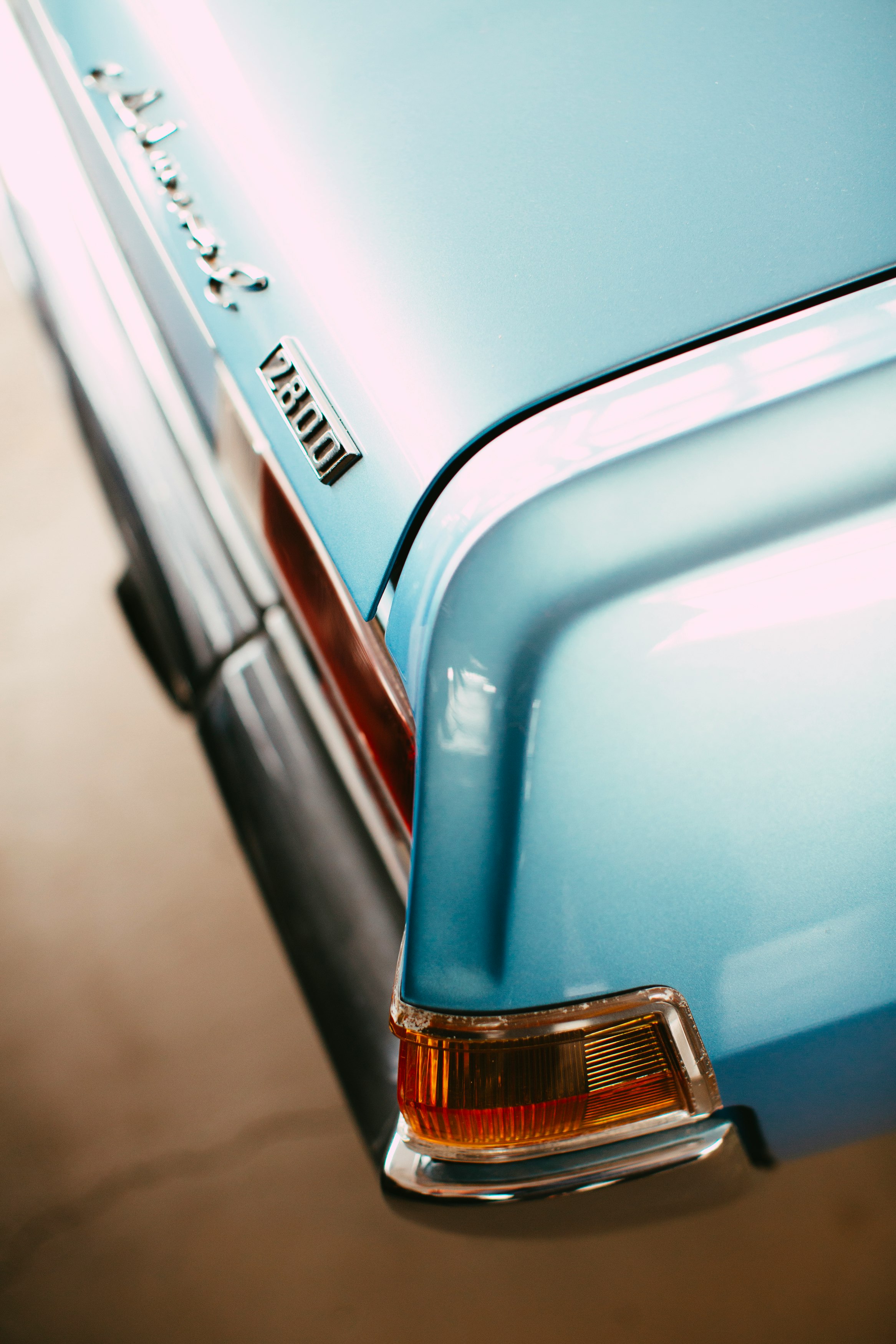 blue car with brown and black license plate